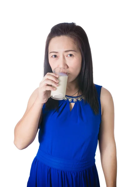 Happy Asian woman with glass of milk in hand isolated on white b — Stock Photo, Image