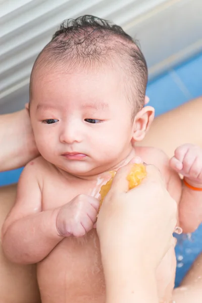 Mãe dar um banho seu bebê recém-nascido, DOF rasa, foco nos olhos . — Fotografia de Stock