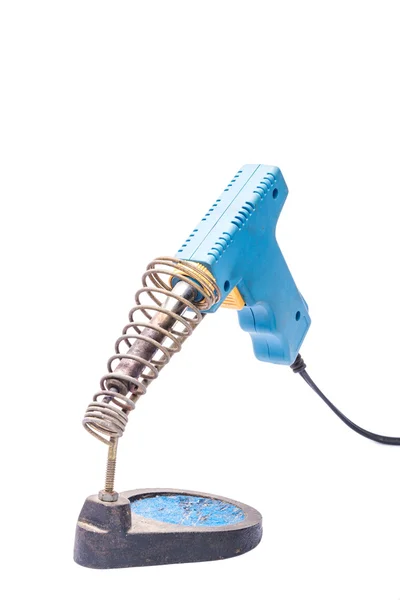 Old rusty blue soldering iron standing on the holder, isolated o — Stock Photo, Image