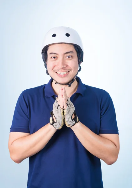 Asian guy welcome Greeting Sawasdee with bicycle helmet and glov — Stock Photo, Image