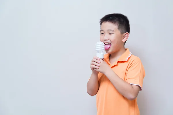 Asian boy joking gesture licking fake ice cream made with energy — Stock Photo, Image