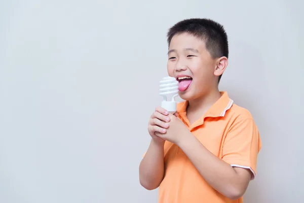Asian boy joking gesture licking fake ice cream made with energy — Stock Photo, Image