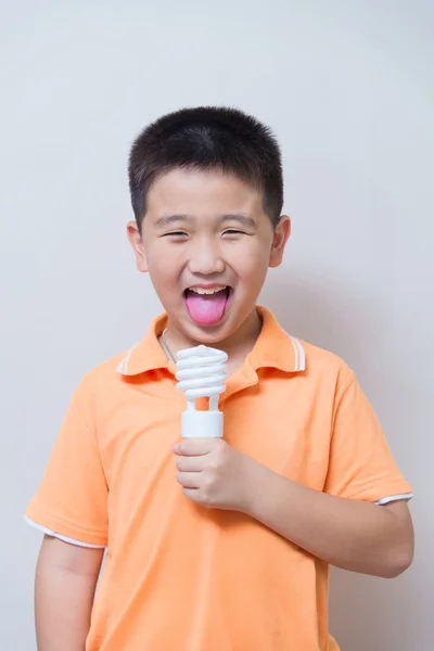 Asian boy joking gesture licking fake ice cream made with energy — Stock Photo, Image