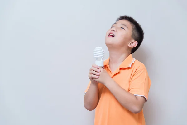 Asian boy joking gesture licking fake ice cream made with energy — Stock Photo, Image