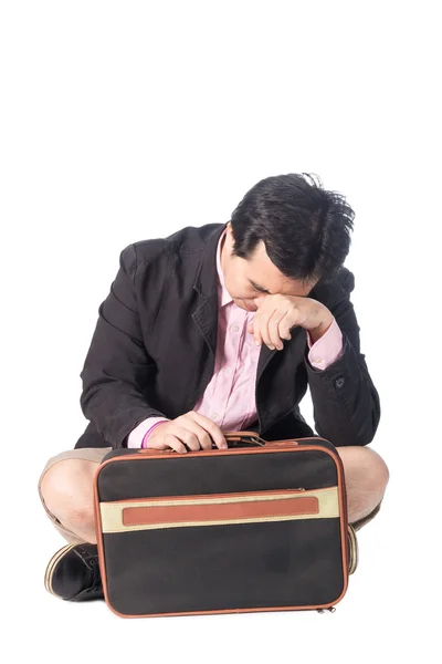 Worried young businessman with briefcase sitting, isolated on wh Royalty Free Stock Photos