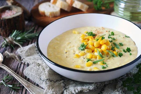 Corn Chowder. American cuisine. Creamy corn soup, green onions and parsley dressing. Rustic style