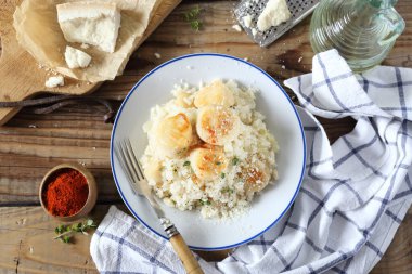 İtalyan mutfağı. İstiridye pilavı, zeytinyağı ve ahşap zemin üzerinde parmesan peyniri. Üst görünüm