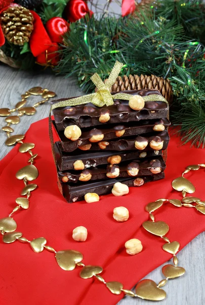 Dark chocolate with hazelnuts in the New Year decor — Stock Photo, Image