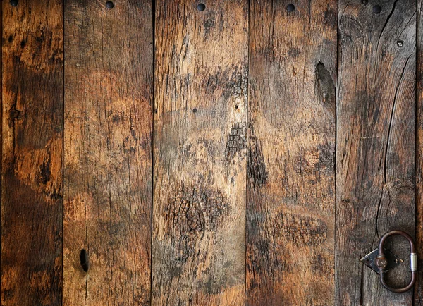 Old wooden door with hardware elements — Stock Photo, Image