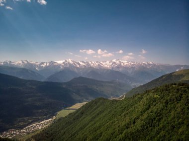 Bulutlar ve yeşil ormanlarla Ushba Dağı 'nın havadan görünüşü. Kafkas Dağları, Gürcistan 'ın Svaneti bölgesi.