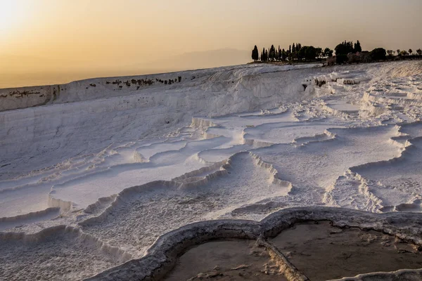 Pamukkale carbonate mineral field at sunset