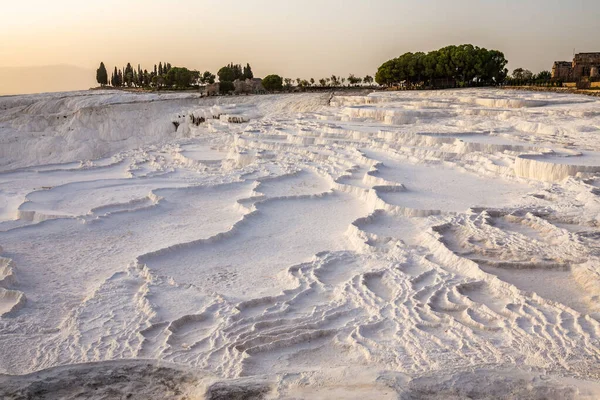 Pamukkale carbonate mineral field at sunset