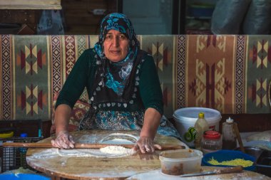 Geleneksel Türk ekmeği yapma süreci. Et veya peynirle doldurulmuş ve levha veya tavada pişirilmiş düz ekmekten yapılmıştır. 