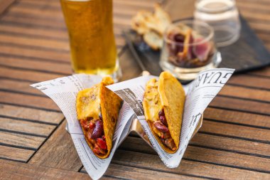 Etli, fasulyeli, peynirli, domatesli ve biberli otantik taco. Bira arka planda. Antalya, Türkiye - 20 Nisan 2022.