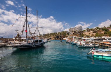 Tekneleri ve yatları olan Old Harbor. Antalya Eski Kent limanı, Taurus dağları ve Akdeniz, Türkiye. Antalya, Türkiye - 20 Nisan 2022.