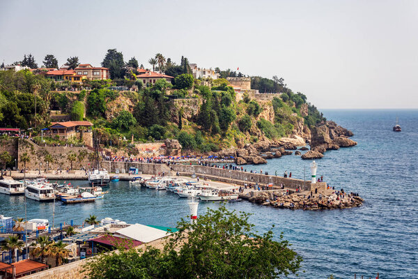 Туристы, наслаждающиеся морским путешествием на парусной яхте, получают доход от старого города. Анталья, Турция - 3 мая 2022 года.