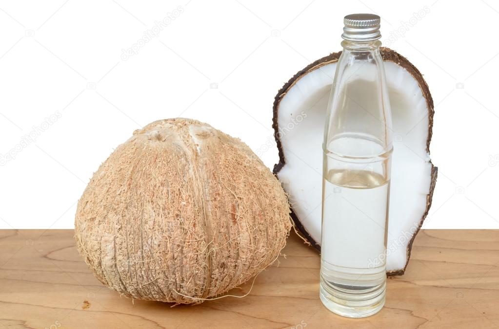 Coconut oil on wooden table with white background