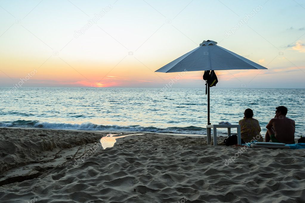Sunset and umbrella at Surin beach Phuket in Thailand
