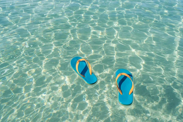 Slippers on the sea water background — Stock Photo, Image