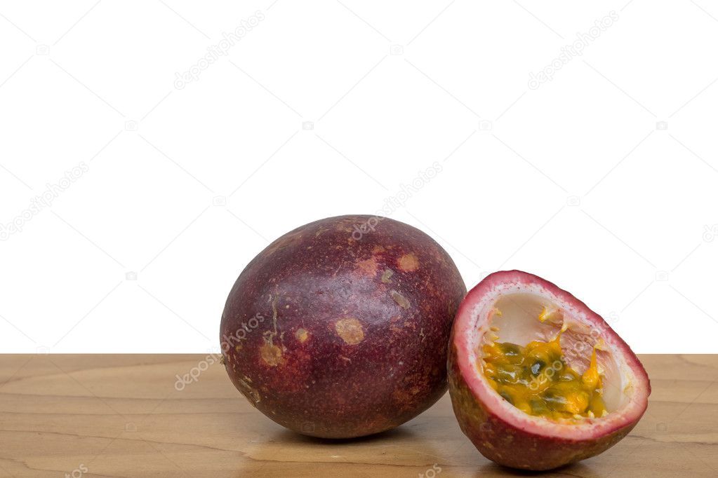 Ripe passion fruit isolated on wooden table with white background