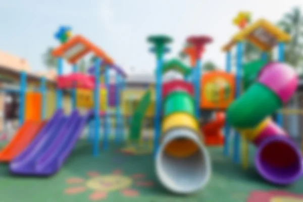 Abstrato borrão crianças playground no fundo do parque público — Fotografia de Stock
