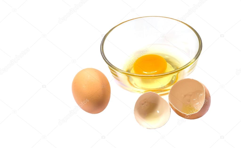 Fresh eggs in a glass bowl on white background