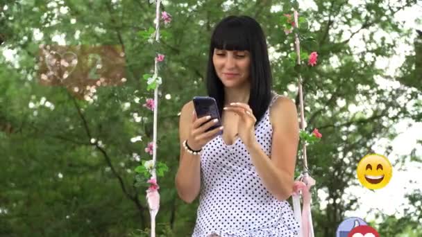 A young woman uses a phone, animation with a user interface-likes, followers, comments for social networks from a smartphone — Stock Video