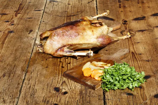 Roasted goose on wooden table — Stock Photo, Image