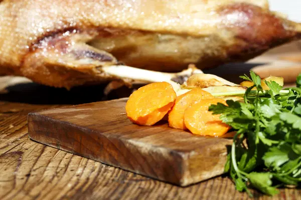 Roasted goose on wooden table — Stock Photo, Image