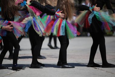 Kids dancing costume performance little girls in bright dress outdoors in the schoolyard concept photo preschool and school music training