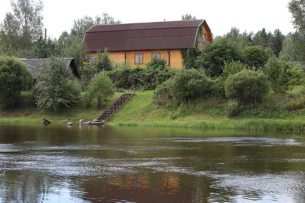 House on the river modern wooden structure with an attic with panorama from the windows.Rent a retreat for a family with a backyard garden.Ecological architecture with a staircase to the water.Russia