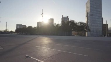 Siyah elbiseli genç erkek ve bayan sporcular şehirde birlikte park numaraları yaparken havadan taklalar ve taklalar atıyorlar.