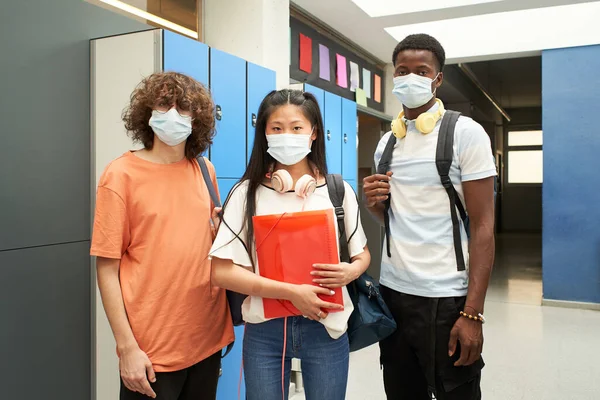 Multiracial students wearing masks to prevent and stop the spread of coronavirus - Lifestyle of the millennial generation during the covid-19 crisis.