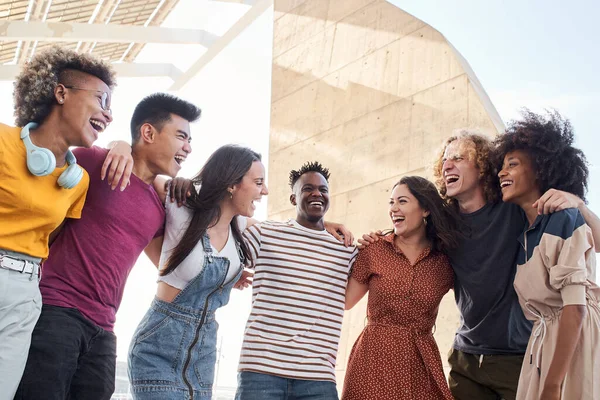 Group of young friends hugging. Concept of multiethnic people, friendship, having fun, equality.