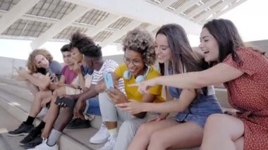 Cep telefonlu bir grup melez genç insan. Heyecanlı öğrenciler teknolojik araçlarını kullanıyorlar. Genç girişimci, arkadaş canlısı, selfie, uygulama, hipster, milenyum.