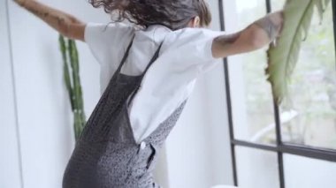 Neşeli genç kazanan elinde cep telefonuyla zıplıyor, evinde coşkuyla dans ediyor. Akıllı telefondan iyi haberler alınıyor. Mutlu kadın bu başarı için heyecanlı..