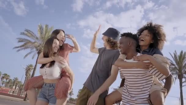 Friends of different ethnicities stacking hand and looking at each other. Group of people having fun and celebrating. Concept of friendship, happiness, joy. — Stock Video