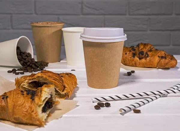 Take Away Coffee with Fresh Croissant With Chocolate and Coffee Beans on wooden background and paper tubes, Copy Space