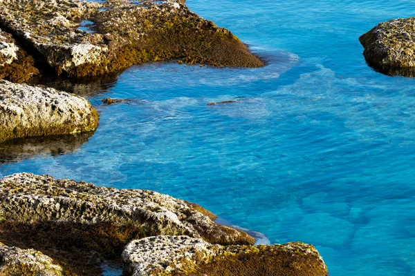 Mediterranean sea beach. Stones and Rocks. Summer day seascape. Clear Water texture. Aerial view, sunny day over sea or ocean. — Stock Photo, Image