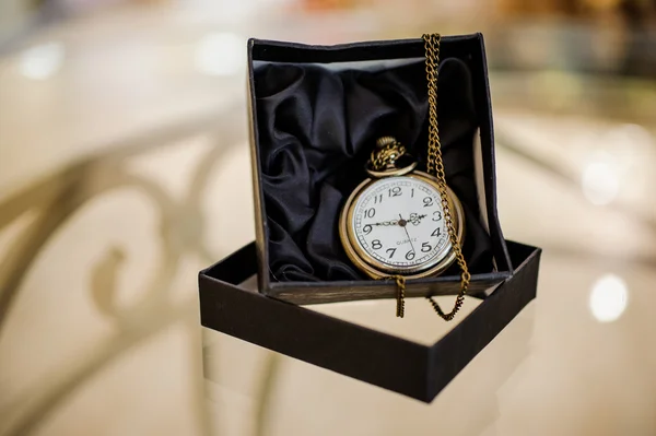 Black box with golden pocket watch — Stock Photo, Image