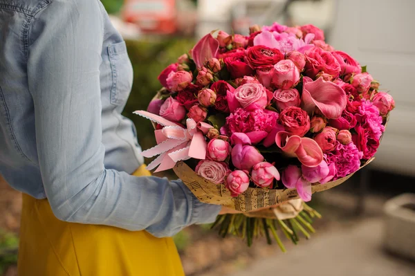 Niña sosteniendo un ramo de flores de color rosa —  Fotos de Stock