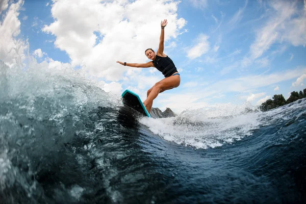 Athletic and active sporty woman ride up on the board on the river — Stock Photo, Image