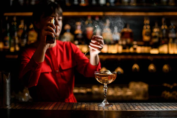 Beautiful crystal glass of cold alcoholic drink stands on the bar counter — Stock Photo, Image