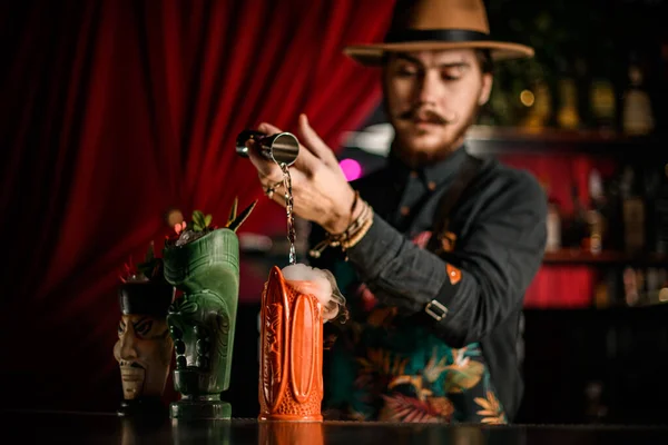 Primer plano de uno de los hermosos vasos de lujo en el mostrador de bar en el que el camarero vierte líquido —  Fotos de Stock