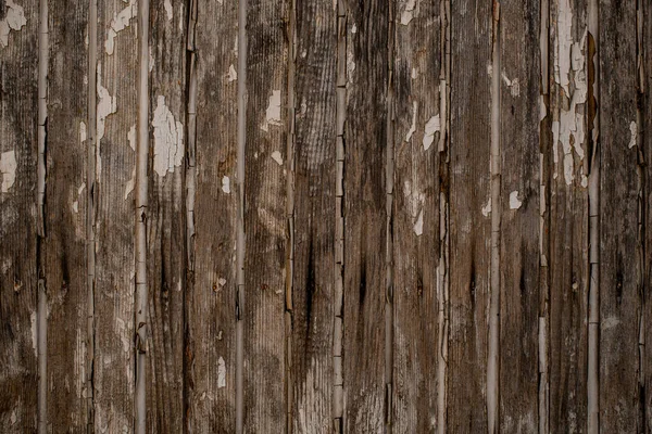 Vertical wood planks with chipped and peeling old white paint. — Stock Photo, Image