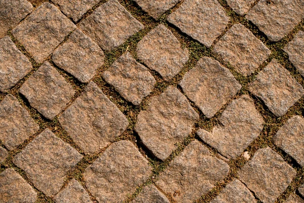 Hintergrund aus quadratischen Natursteinpflastersteinen — Stockfoto