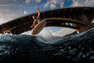 Dalgaların üzerinden atlarken erkek wakeboardcunun güzel manzarası