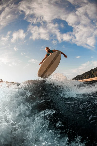 水飛びする波の上を巧みに飛び跳ねるオスのウェイクボードの姿 — ストック写真