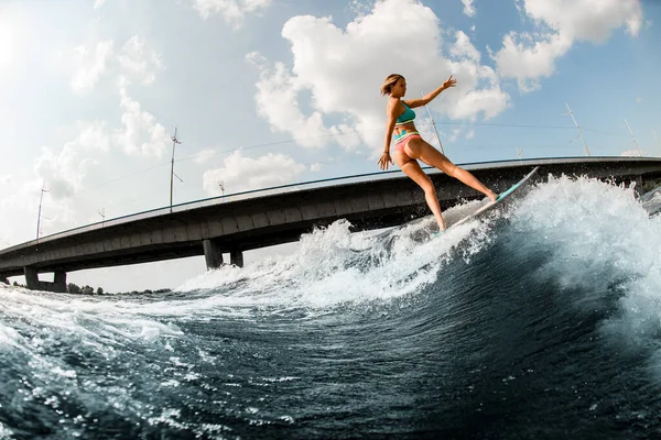 Hermosa mujer wakesurfer hábilmente montar la ola a bordo en el soleado día de verano —  Fotos de Stock