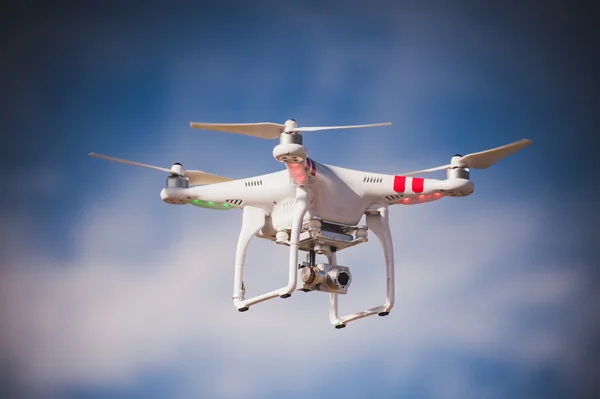 Flygende drone med kamera på himmelen stockfoto